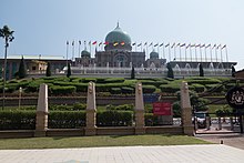 Large building with a series of flags in front of it