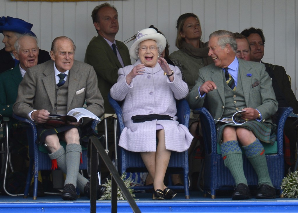 Members of Britain's royal family cheer as competitors participate in a sack race at the Braemar Gathering in Braemar