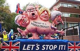 Anti-Brexit protest in Manchester (2017) by German sculptor Jacques Tilly, with an effigy depicting Conservative MPs David Davis, Michael Gove, Boris Johnson and Theresa May