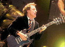 Angus Young performing in Cologne, Germany in 2001, during the Stiff Upper Lip World Tour.