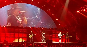 AC/DC with Axl Rose (shown in centre and top left), performing in Washington, D.C. in 2016 during the Rock or Bust World Tour