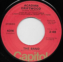Single label for 'Acadian Driftwood' by the Band. Written by Robbie Robertson, From the LP Northern Lights Southern Cross, on Capitol Records. Performed and produced by The Band. 0:14 intro, track length 3:48. Capitol 4316.