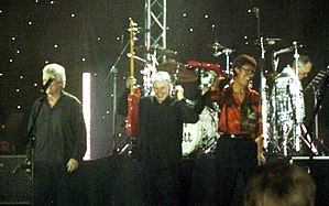 The Shadows performing in Denmark, featuring long-time members from left Bruce Welch and (far right) Hank Marvin; Brian Bennett featured in background on drums.