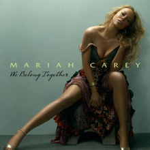 A blonde woman sitting in a bed in front of a light black background, and wearing a patterned dress. "Mariah Carey" is written on her image in green font, with "We Belong Together" written in black, cursive font below it.