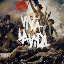 A close-up of Eugène Delacroix's 1830 painting Liberty Leading the People. The words "VIVA LA VIDA" are written in white painting in the center of the image.