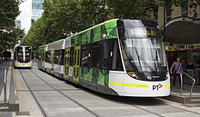 Two E-Class trams on Bourke St as part of the Melbourne tram network.
