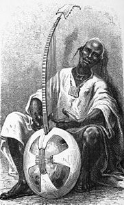 Sambou, jali of Niantanso, Mali, with a Kamalengoni (a relation to the Kora) in 1872.