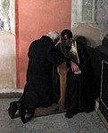 A penitent confessing his sins in a Ukrainian Catholic church